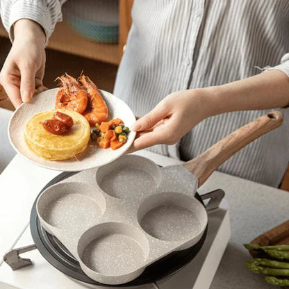 3-mould frying pan on a hob with pancakes in each section – divided non-stick pan