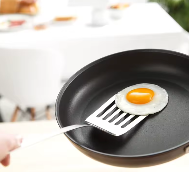 Precision spatulas in use folding batter in a mixing bowl – baking kitchen set