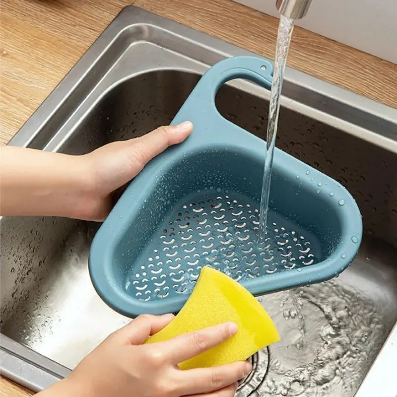 Sink organiser with sponge and washing-up brush stored neatly beside a tap