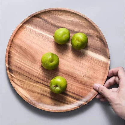 Pure Acacia artisan plates stacked on a wooden table – natural wood serving plates