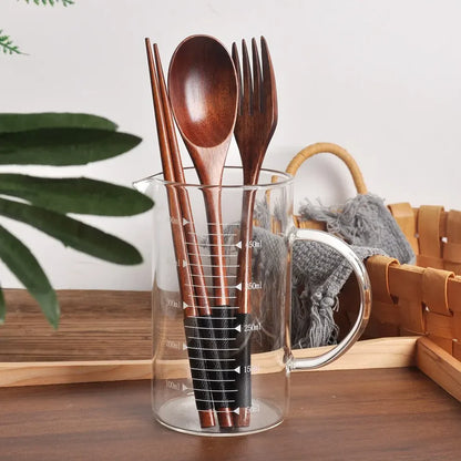 Zen Elegance cutlery in a wooden holder on a dining table – kitchen gift idea