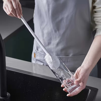 Siliclean silicone scrubber in use cleaning a non-stick pan – gentle dish cleaner